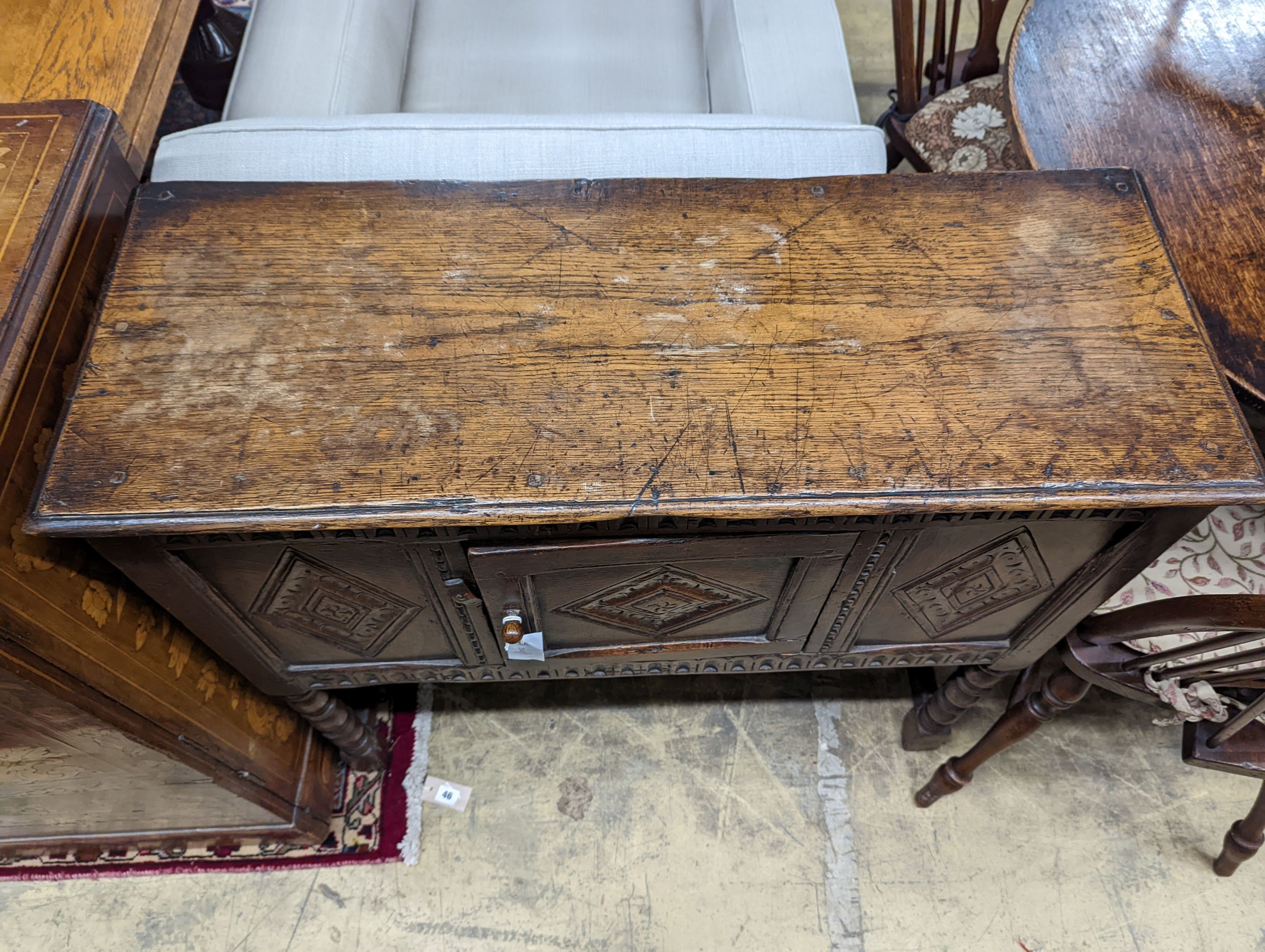 An 18th century style carved oak side cabinet, width 90cm, depth 35cm, height 83cm